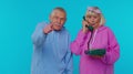 Senior grandparents pensioners talking on wired vintage telephone of 80s, says hey you call us back