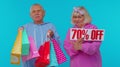 Senior grandparents showing shopping bags and Up To 70 Percent Off banner text, Black Friday holiday