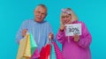 Senior grandparents showing shopping bags and Up To 30 Percent Off banner text, Black Friday holiday