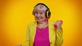 Senior granny woman listening music via headphones, working out, lifting pink dumbbells, healthcare Royalty Free Stock Photo