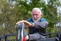 Senior gray haired man stretching legs outdoors. Royalty Free Stock Photo