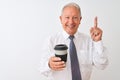 Senior grey-haired businessman drinking take away coffee over isolated white background surprised with an idea or question Royalty Free Stock Photo