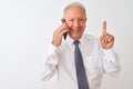 Senior grey-haired businessman talking on the smartphone over isolated white background surprised with an idea or question Royalty Free Stock Photo