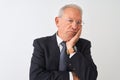 Senior grey-haired businessman wearing suit and glasses over isolated white background thinking looking tired and bored with Royalty Free Stock Photo