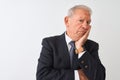 Senior grey-haired businessman wearing suit standing over isolated white background thinking looking tired and bored with Royalty Free Stock Photo