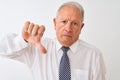 Senior grey-haired businessman wearing tie standing over isolated white background with angry face, negative sign showing dislike Royalty Free Stock Photo