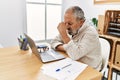 Senior grey-haired man stressed working at office Royalty Free Stock Photo