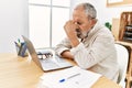 Senior grey-haired man stressed working at office Royalty Free Stock Photo