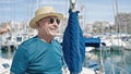 Senior grey-haired man tourist wearing summer hat and sunglasses at boat Royalty Free Stock Photo