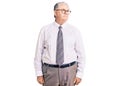 Senior grey-haired man wearing business clothes smiling looking to the side and staring away thinking Royalty Free Stock Photo