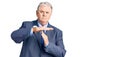 Senior grey-haired man wearing business jacket doing time out gesture with hands, frustrated and serious face Royalty Free Stock Photo