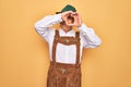 Senior grey-haired man wearing german traditional octoberfest suit over yellow background Doing heart shape with hand and fingers Royalty Free Stock Photo