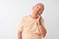 Senior grey-haired man wearing striped t-shirt standing over isolated white background with hand on chin thinking about question, Royalty Free Stock Photo