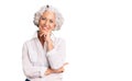 Senior grey-haired woman wearing casual clothes looking confident at the camera with smile with crossed arms and hand raised on Royalty Free Stock Photo