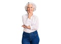 Senior grey-haired woman wearing casual clothes looking confident at the camera smiling with crossed arms and hand raised on chin Royalty Free Stock Photo