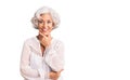 Senior grey-haired woman wearing casual clothes looking confident at the camera smiling with crossed arms and hand raised on chin Royalty Free Stock Photo