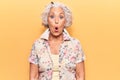 Senior grey-haired woman wearing casual clothes scared and amazed with open mouth for surprise, disbelief face Royalty Free Stock Photo