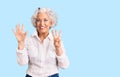 Senior grey-haired woman wearing casual clothes showing and pointing up with fingers number eight while smiling confident and Royalty Free Stock Photo