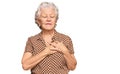 Senior grey-haired woman wearing casual clothes smiling with hands on chest with closed eyes and grateful gesture on face Royalty Free Stock Photo