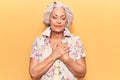 Senior grey-haired woman wearing casual clothes smiling with hands on chest with closed eyes and grateful gesture on face Royalty Free Stock Photo