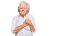 Senior grey-haired woman wearing casual clothes smiling with hands on chest with closed eyes and grateful gesture on face Royalty Free Stock Photo