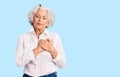 Senior grey-haired woman wearing casual clothes smiling with hands on chest with closed eyes and grateful gesture on face Royalty Free Stock Photo