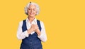 Senior grey-haired woman wearing casual clothes smiling with hands on chest with closed eyes and grateful gesture on face Royalty Free Stock Photo