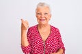 Senior grey-haired woman wearing red casual jacket standing over isolated white background smiling with happy face looking and Royalty Free Stock Photo