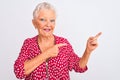 Senior grey-haired woman wearing red casual jacket standing over isolated white background smiling and looking at the camera Royalty Free Stock Photo