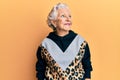 Senior grey-haired woman wearing sportswear looking to side, relax profile pose with natural face and confident smile Royalty Free Stock Photo