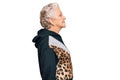 Senior grey-haired woman wearing sportswear looking to side, relax profile pose with natural face with confident smile Royalty Free Stock Photo