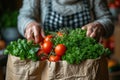 Senior hands holding paper bag full of fresh vegetables