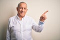 Senior handsome businessman wearing elegant shirt standing over isolated pink background with a big smile on face, pointing with Royalty Free Stock Photo