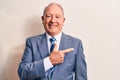 Senior handsome grey-haired businessman wearing elegant suit over white background smiling cheerful pointing with hand and finger Royalty Free Stock Photo