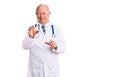 Senior handsome grey-haired man wearing doctor coat and stethoscope disgusted expression, displeased and fearful doing disgust