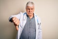 Senior handsome hoary doctor man wearing coat and stethoscope over white background looking unhappy and angry showing rejection Royalty Free Stock Photo