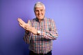 Senior handsome hoary man wearing casual colorful shirt over isolated purple background clapping and applauding happy and joyful,