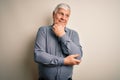 Senior handsome hoary man wearing casual shirt standing over isolated white background with hand on chin thinking about question, Royalty Free Stock Photo