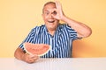 Senior handsome man with gray hair eating sweet watermelon slice smiling happy doing ok sign with hand on eye looking through Royalty Free Stock Photo