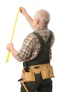 Senior handyman measuring