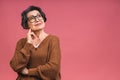 Senior happy aged business woman wearing glasses. Beautiful old woman, grandmother looking at camera and smiling. Isolated on pink Royalty Free Stock Photo