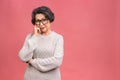 Senior happy aged business woman wearing glasses. Beautiful old woman, grandmother looking at camera and smiling. Isolated on pink Royalty Free Stock Photo