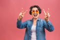 Senior happy aged business woman wearing glasses. Beautiful old woman, grandmother looking at camera and smiling. Isolated on pink Royalty Free Stock Photo