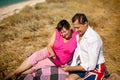 Senior happy couple having fun using digital tablet pc at beach during moment of relax Royalty Free Stock Photo