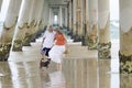 Senior happy couple laughing on beach holiday with pet puppy dog