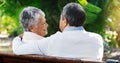 Senior, happy couple and relax with bench at park for love, embrace or hug in outdoor romance. Rear view of elderly man