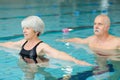 senior happy couple in swimming pool lesson Royalty Free Stock Photo