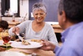 Senior, happy woman and family with food for thanksgiving dinner, meal or serving at the table. Mature and hungry couple Royalty Free Stock Photo