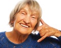 Senior happy woman is making a call me gesture Royalty Free Stock Photo