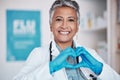 Senior, happy woman and portrait of doctor with heart hands in healthcare, service or love at hospital. Mature female Royalty Free Stock Photo